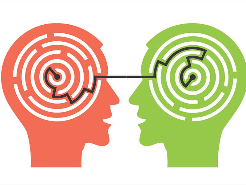 Two heads with a picture of a maze within each