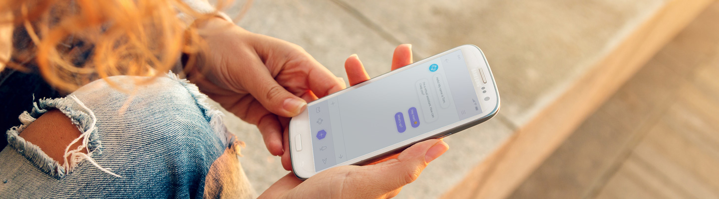 Person holding a phone that has a chatbot app open
