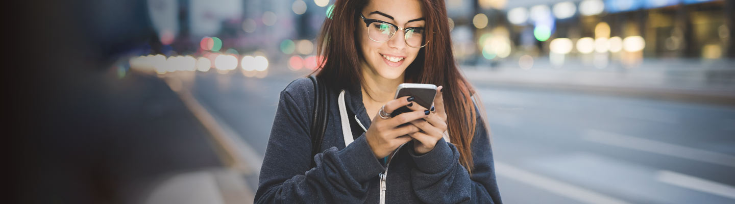 Girl holding a cell phone - mobile banking