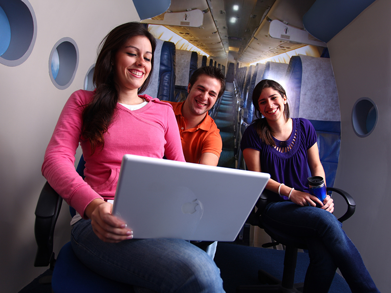 Generation Y team members looking at a computer in an office