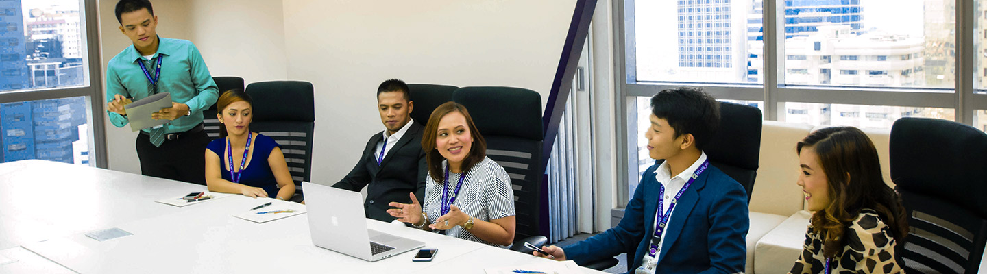 TELUS International employees in a boardroom