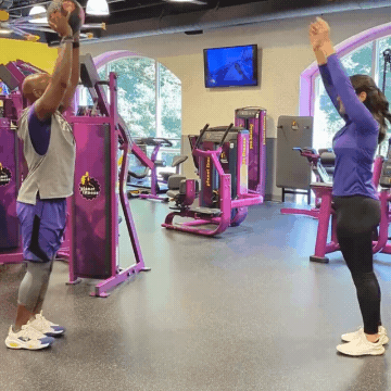 Man and woman working out in Planet Fitness gym doing forward ball lunge exchange exercises