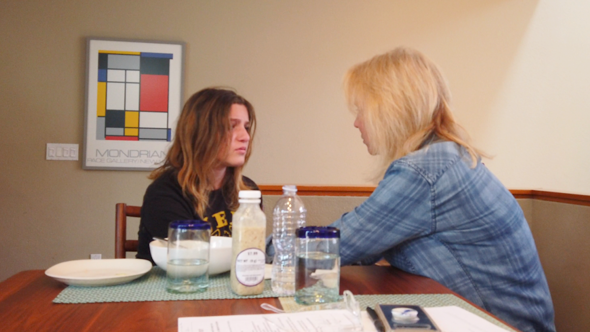 Sevey Morton and her mom, Laura Morton, are pictured talking at the dinner table.