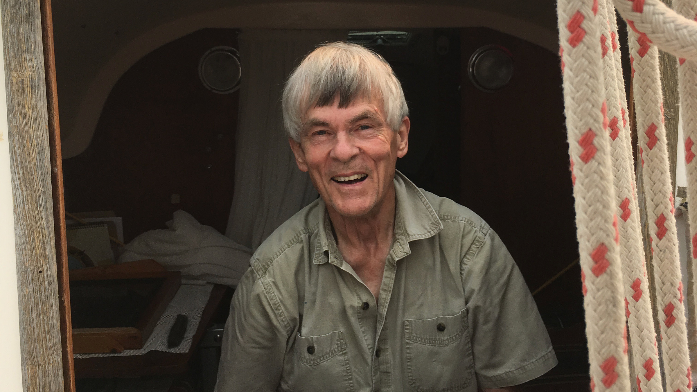 The author’s grandfather working on a little red sailboat called “Freedom.”