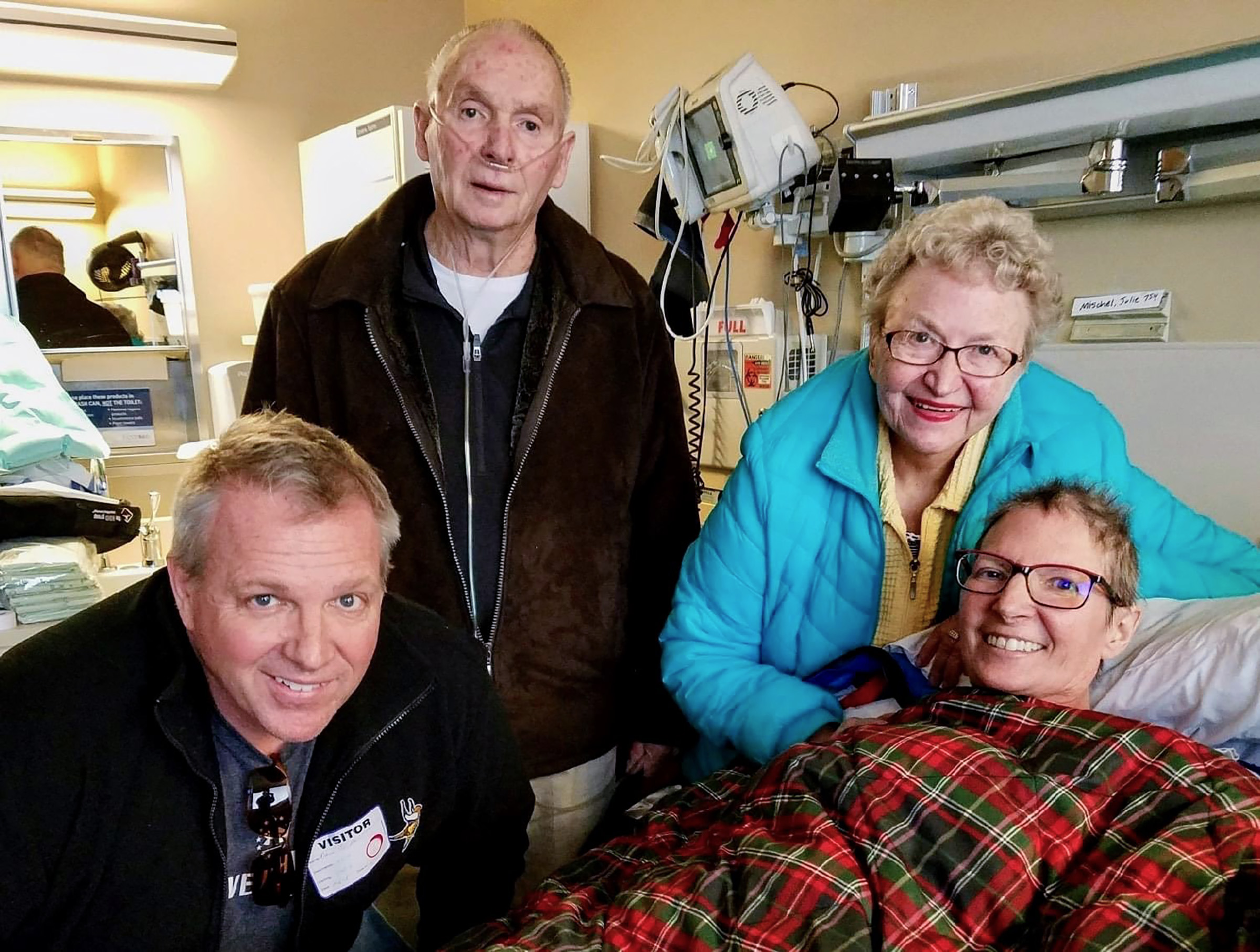 Dave Dondoneau in a hospital room with his parents, Vern and Joan Dondoneau, and his sister, Julie Dondaneau.