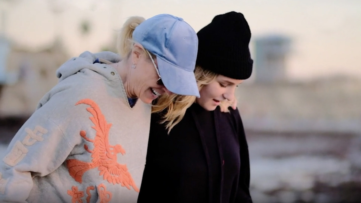 Laura Morton is pictured with her arm around her daughter, Sevey Morton, as they go on a walk.