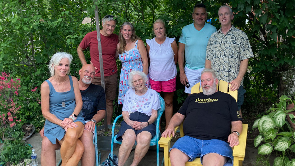 Judi Kettler, above her mother (center), is surrounded by family members in a snapshot outdoors.