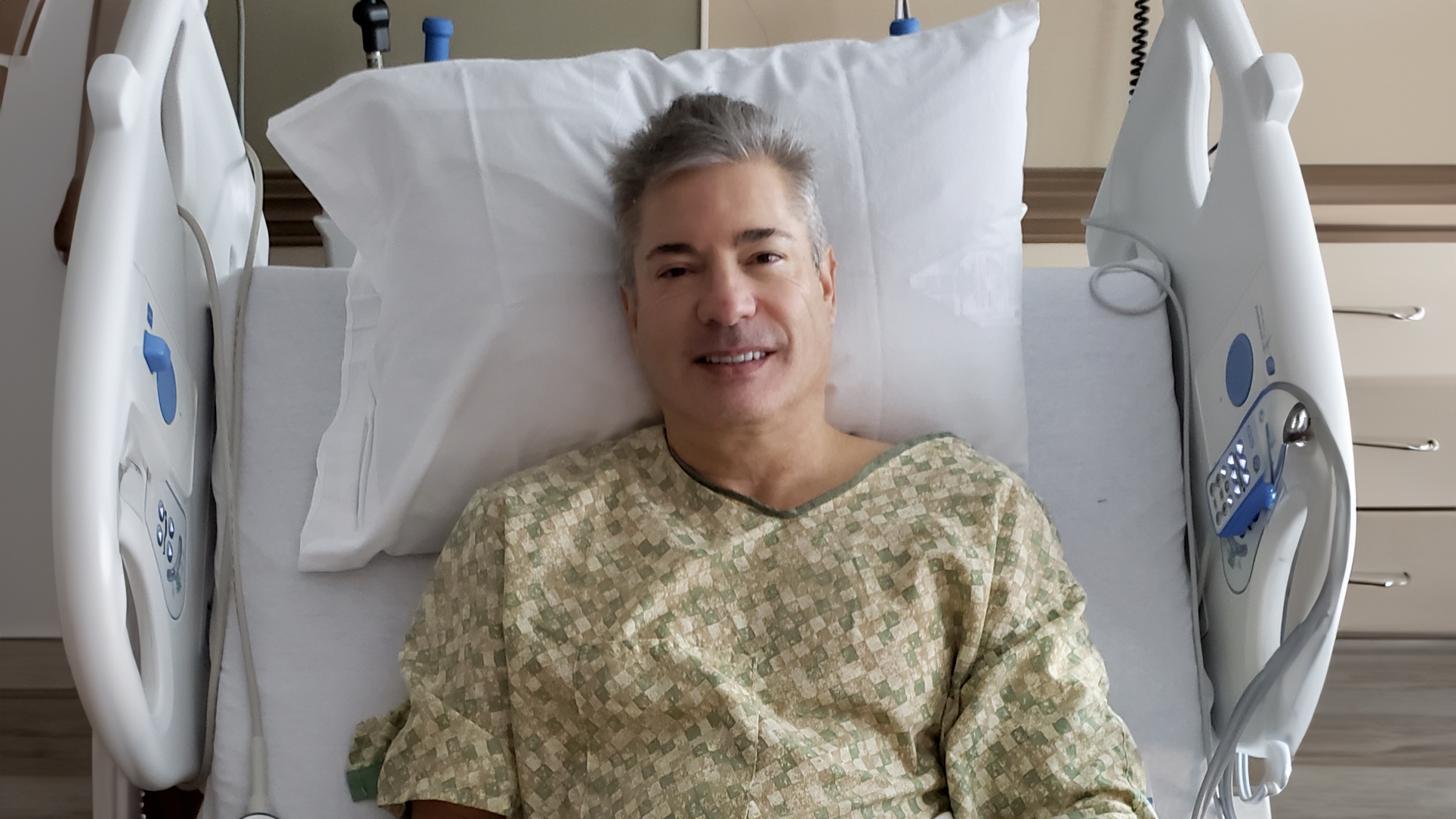 Christian Scarborough is pictured in the hospital bed after knee surgery.