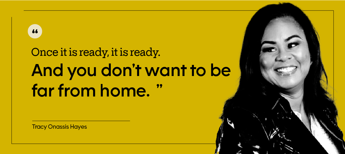 This is a headshot of Tracy Onassis Hayes, who is wearing a black jacket and looking away from the camera.