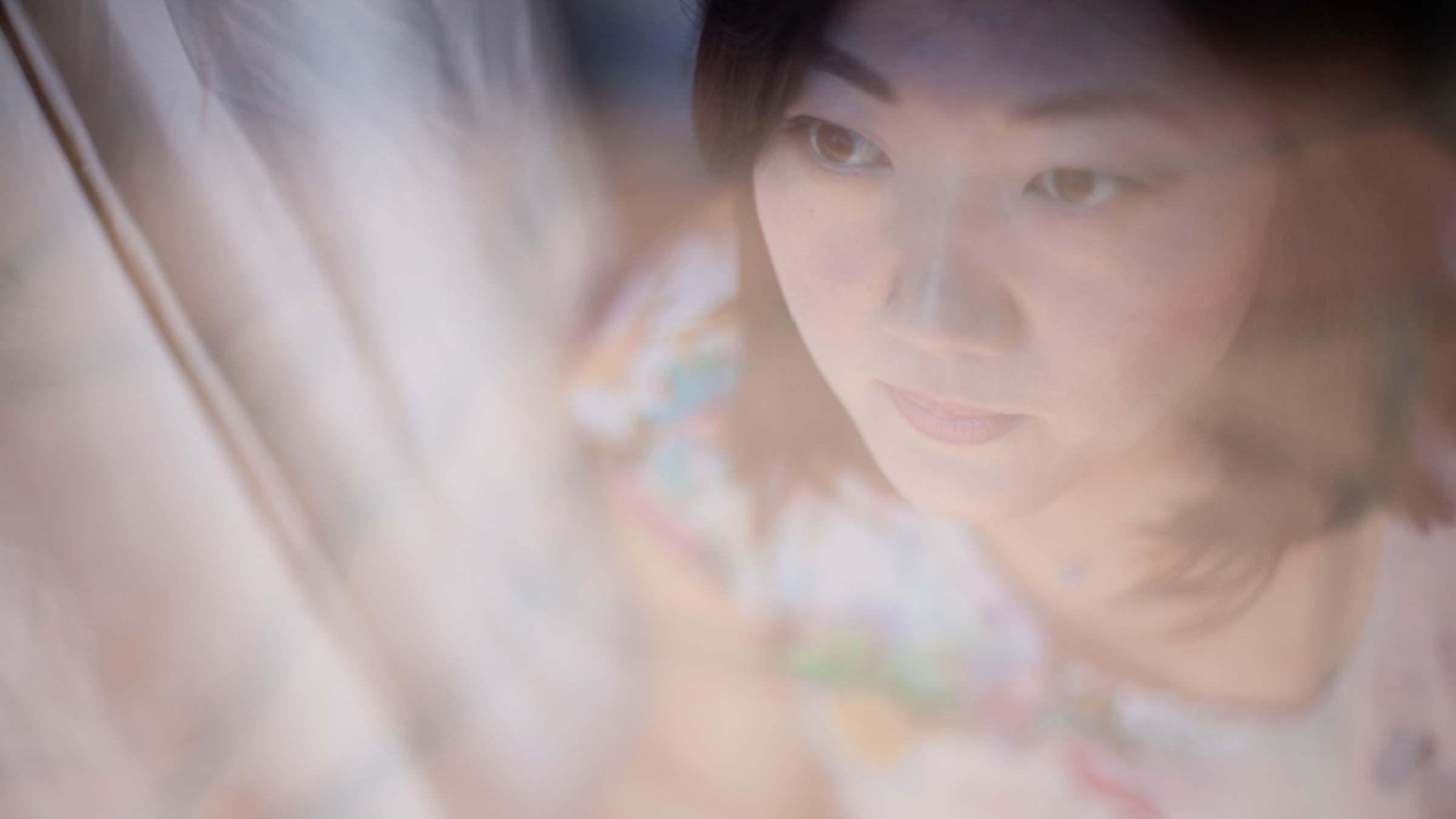 Christine H. Lee is pictured reflected in a foggy window.