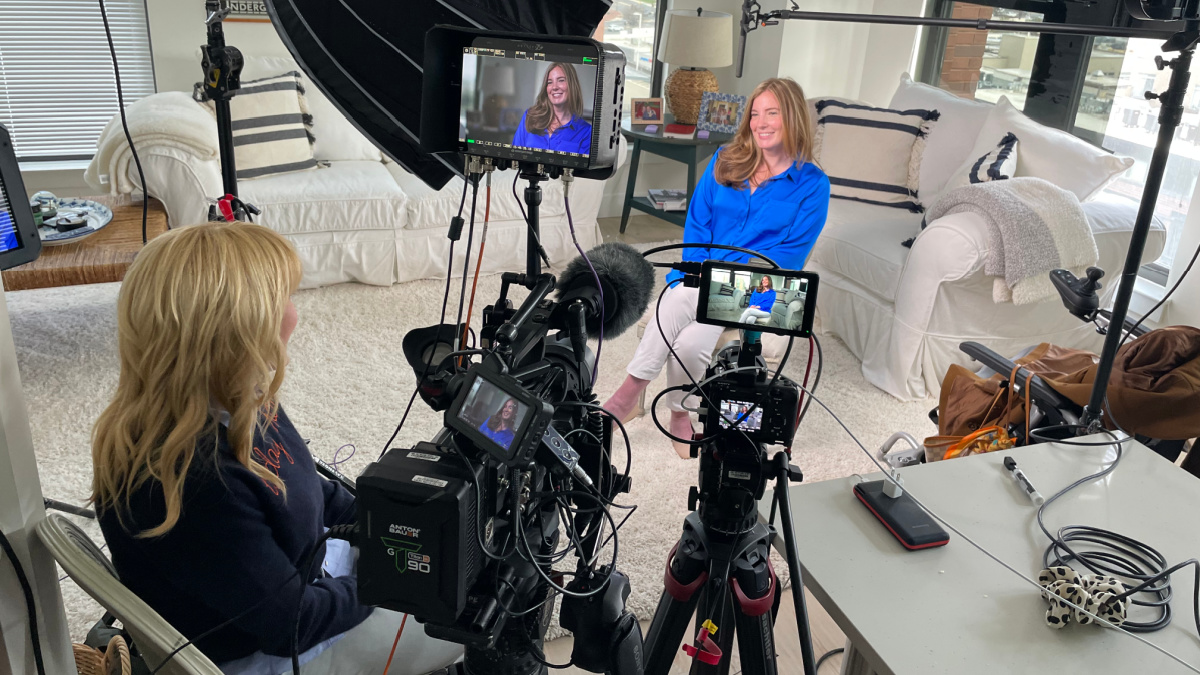 Brooke Eby is pictured in a living room being filmed for a segment of a morning talk show.
