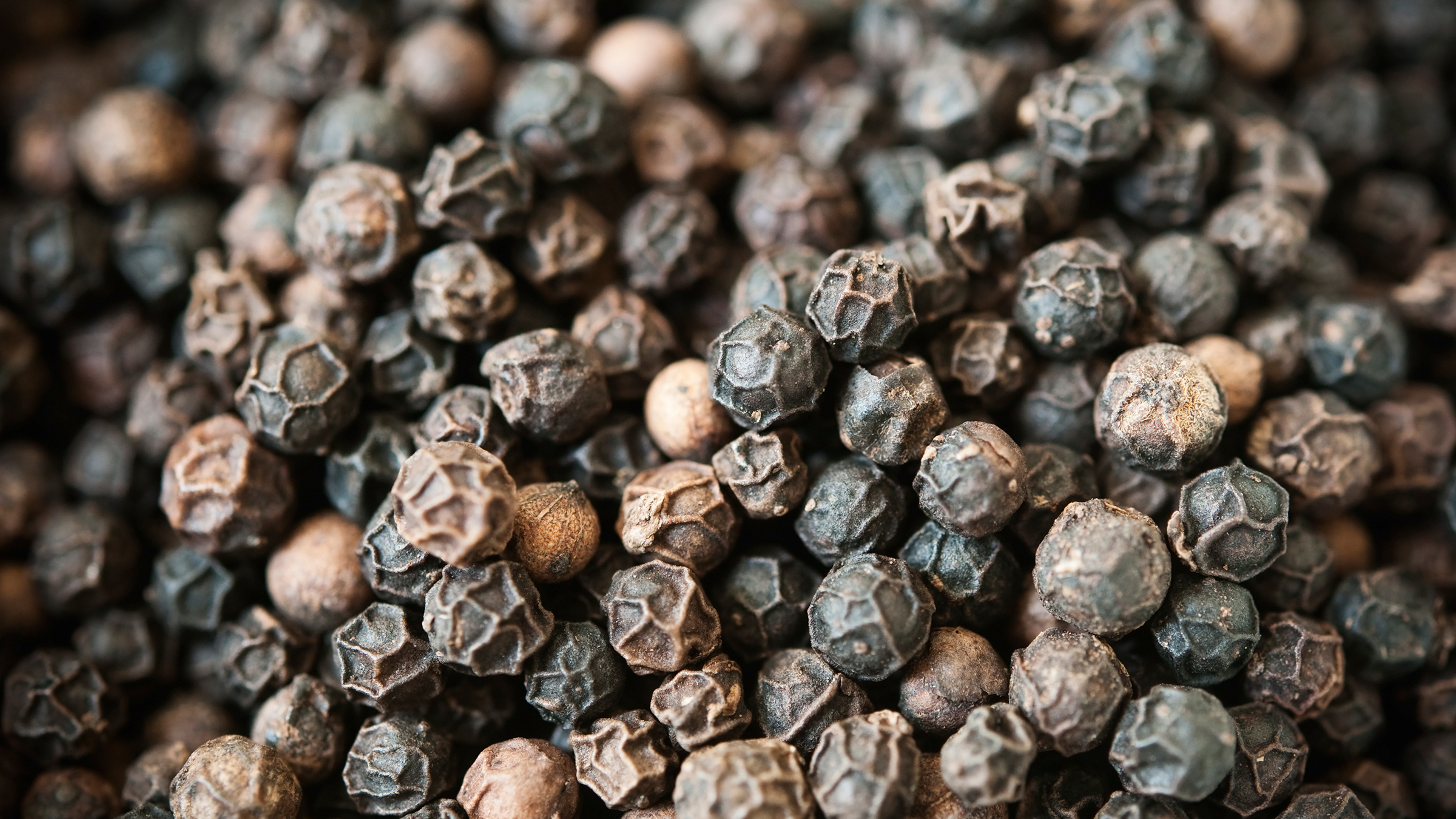 Close-up of whole black peppercorns