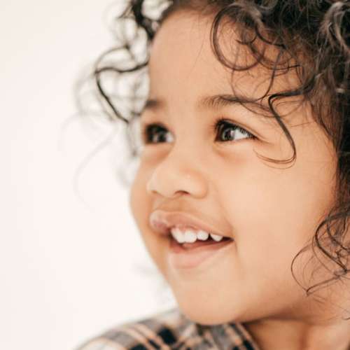 A young toddler smiling. 