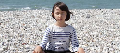 A photo of a child meditating.