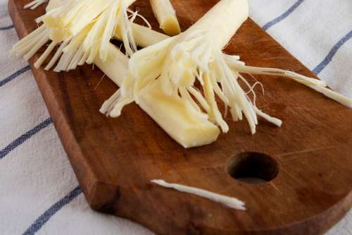 String cheese on cutting board closeup