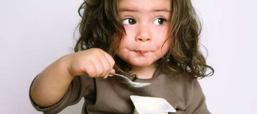 A child eating yogurt.