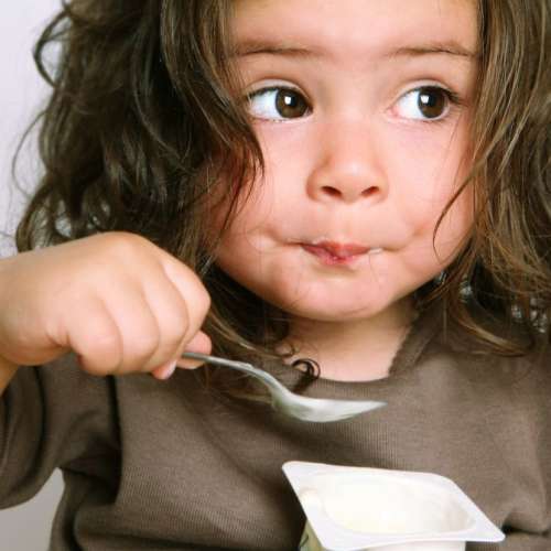 A child eating yogurt.