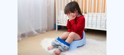 Toddler on potty covering face