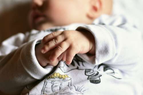 Close-up of baby hands while taking nap
