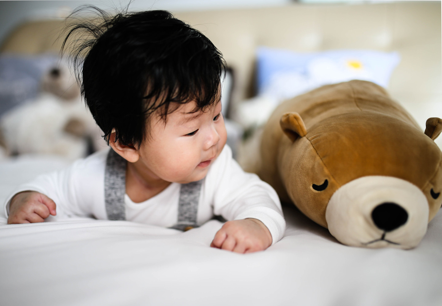 infant awake in bed with lovey