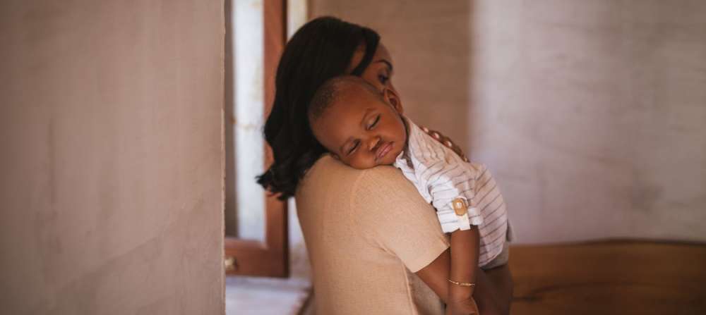 A caregiver holding a baby.