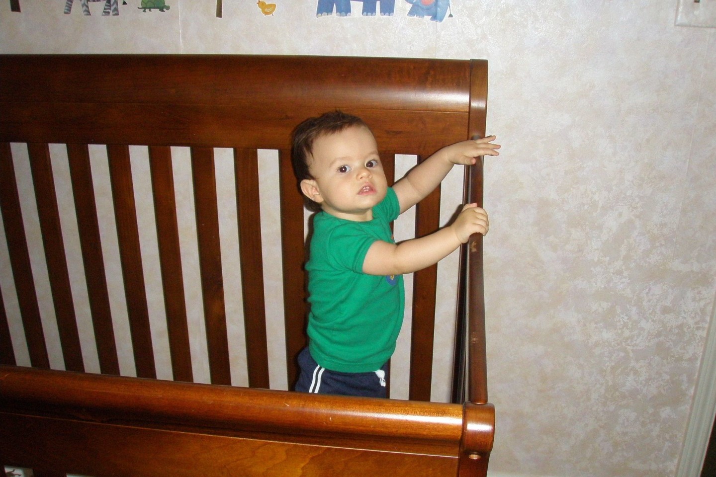Amber's son at 11 months standing up in crib