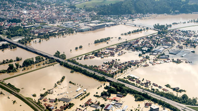Nach einem Dammbruch werden weite Landstriche überflutet.