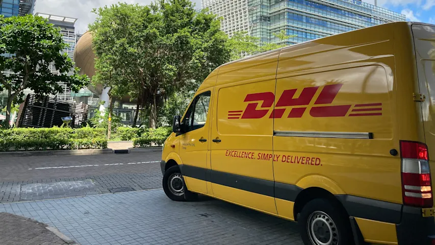 Image of a DHL delivery truck outside on a sunny day