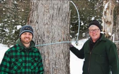 John Buck (right) with his son, James (left), work closely together on the family’s maple syrup operation.
