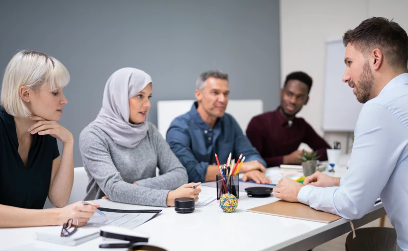 An interview situation with a panel of 4 interviewing a person.