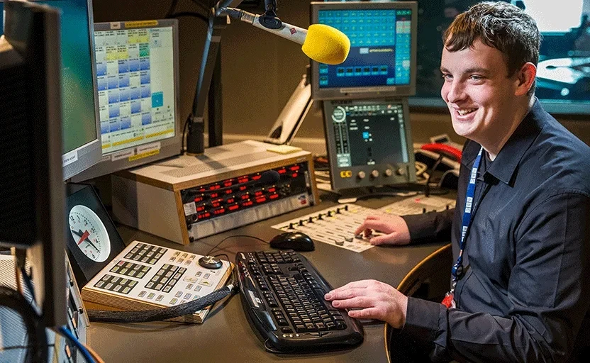 man smiling working in front of computer