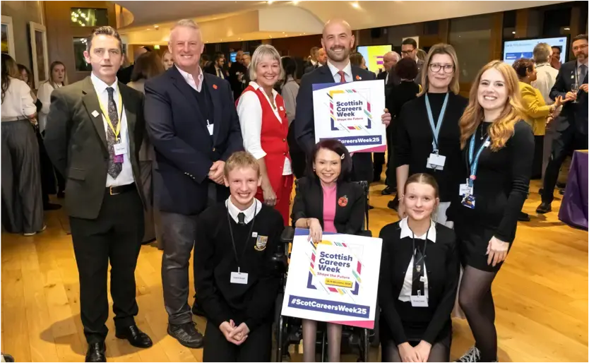 A group of people - school pupils, Skills Development staff and politicians - at an event.