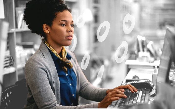 A person typing up their cover letter on a computer.