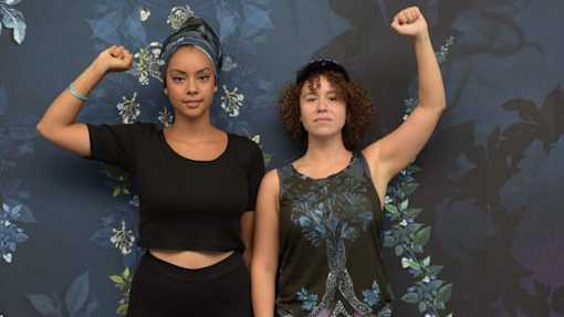 Two women lifting up their fist