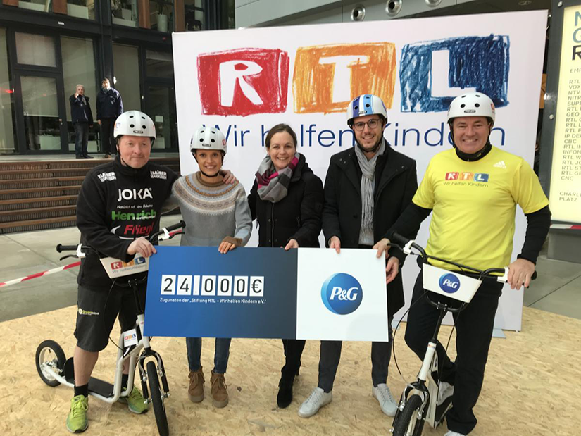 RTL event members holding a big check from P&G