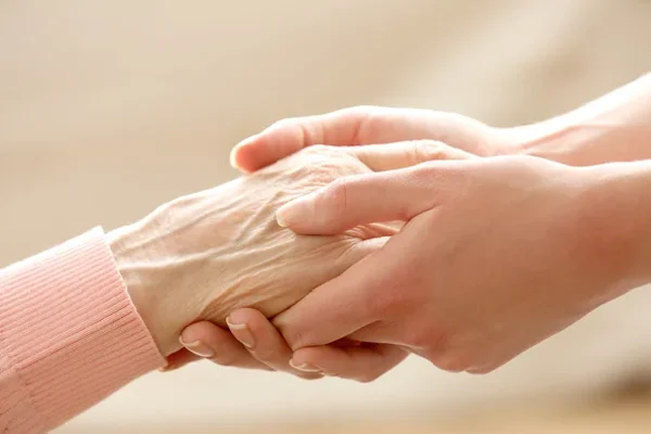 caregiver holding hands