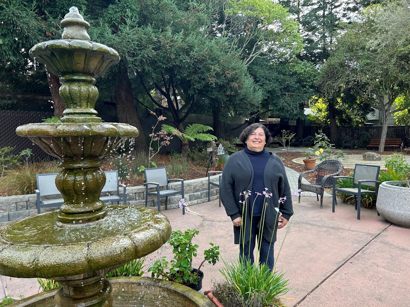 Participant standing outside by fountain