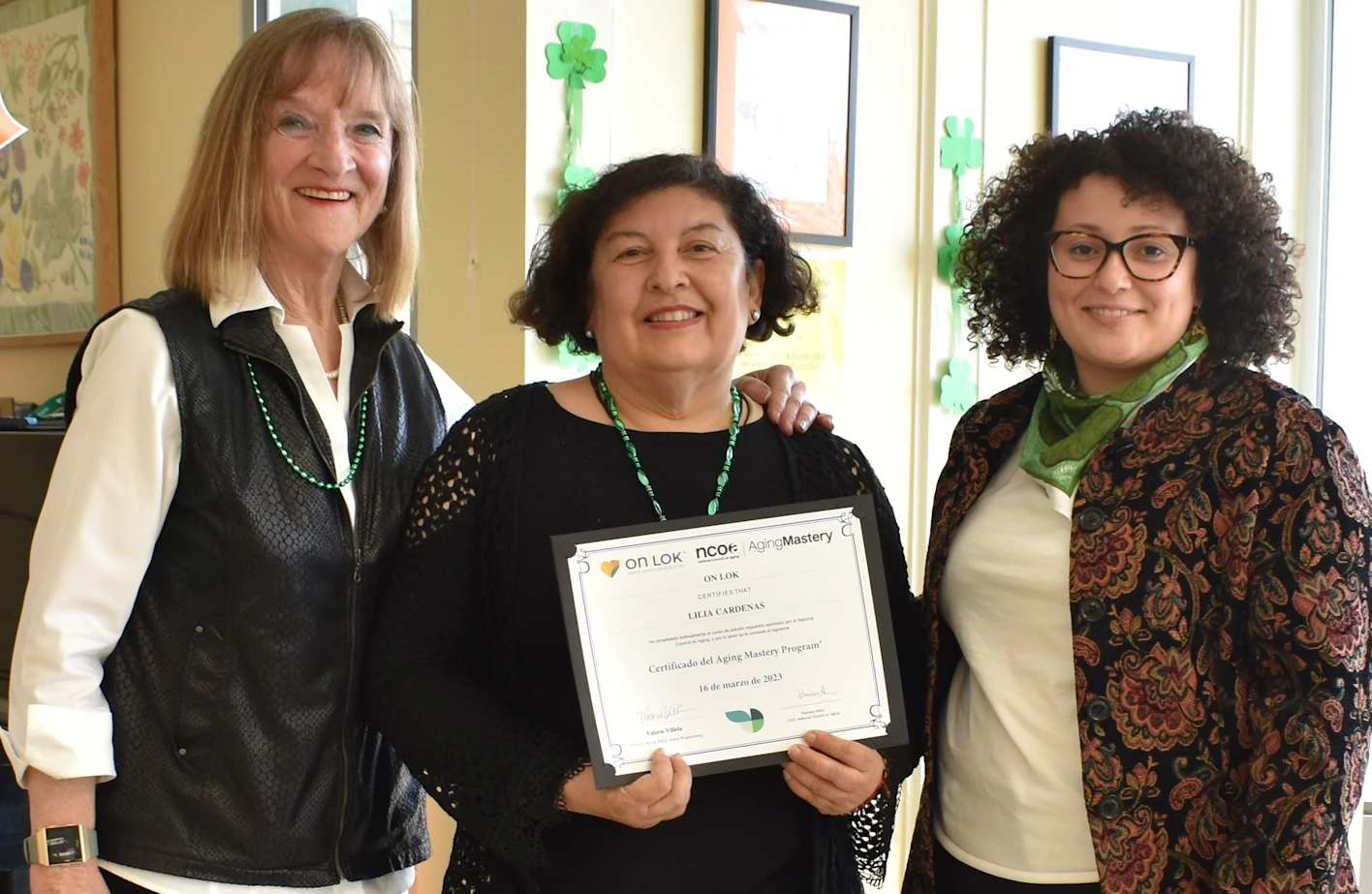 Lilia holding a certificate for the Aging Mastery Program.