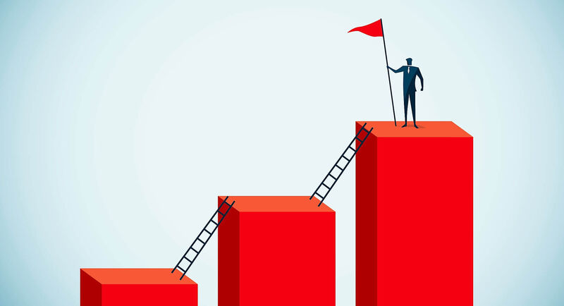figure holding a flag on the tallest of a series of pillars connected by ladders