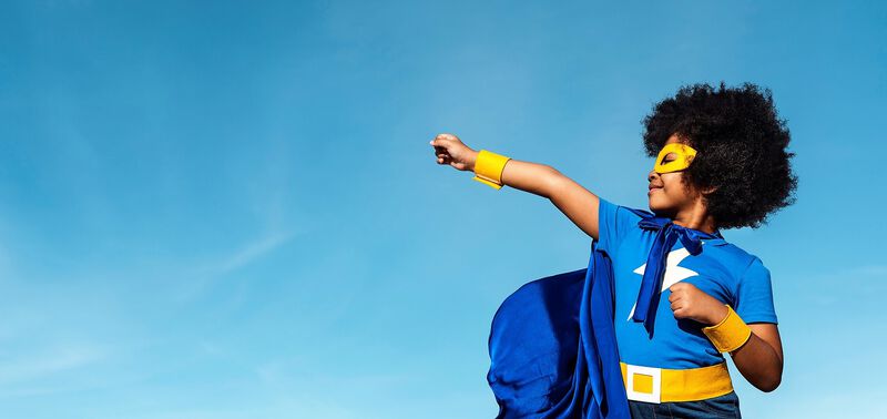 child dressed as a superhero