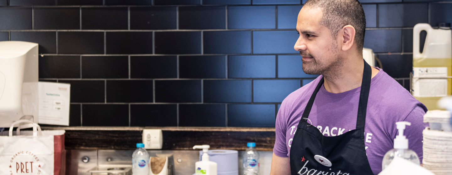 Smiling barista purple tee-shirt
