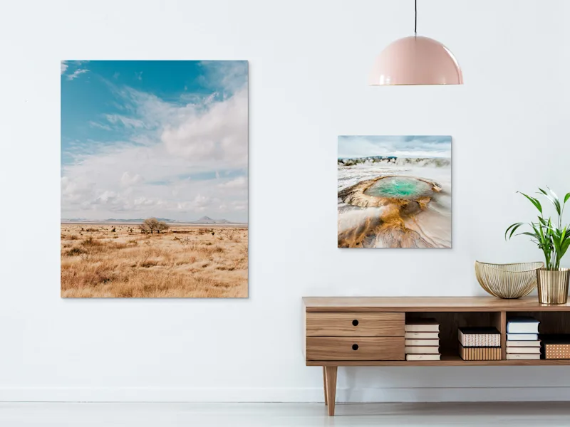 Direct Print on Forex Two motifs on direct print on forex on a wall in a living room. One with clouds drifting over a parched landscape and one of a geyser.