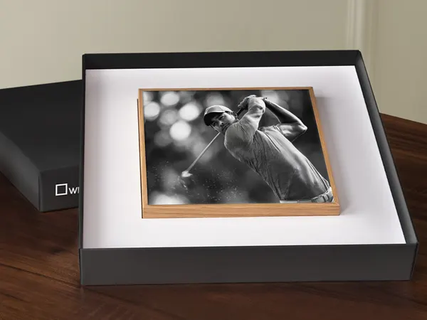 Artbox Gift Edition Black and white framed photograph of a golfer mid-swing displayed in an open presentation box on a wooden surface
