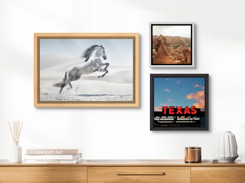 Photo in Floater Frame Three images framed in a Floater Frame on a wall in a living room.