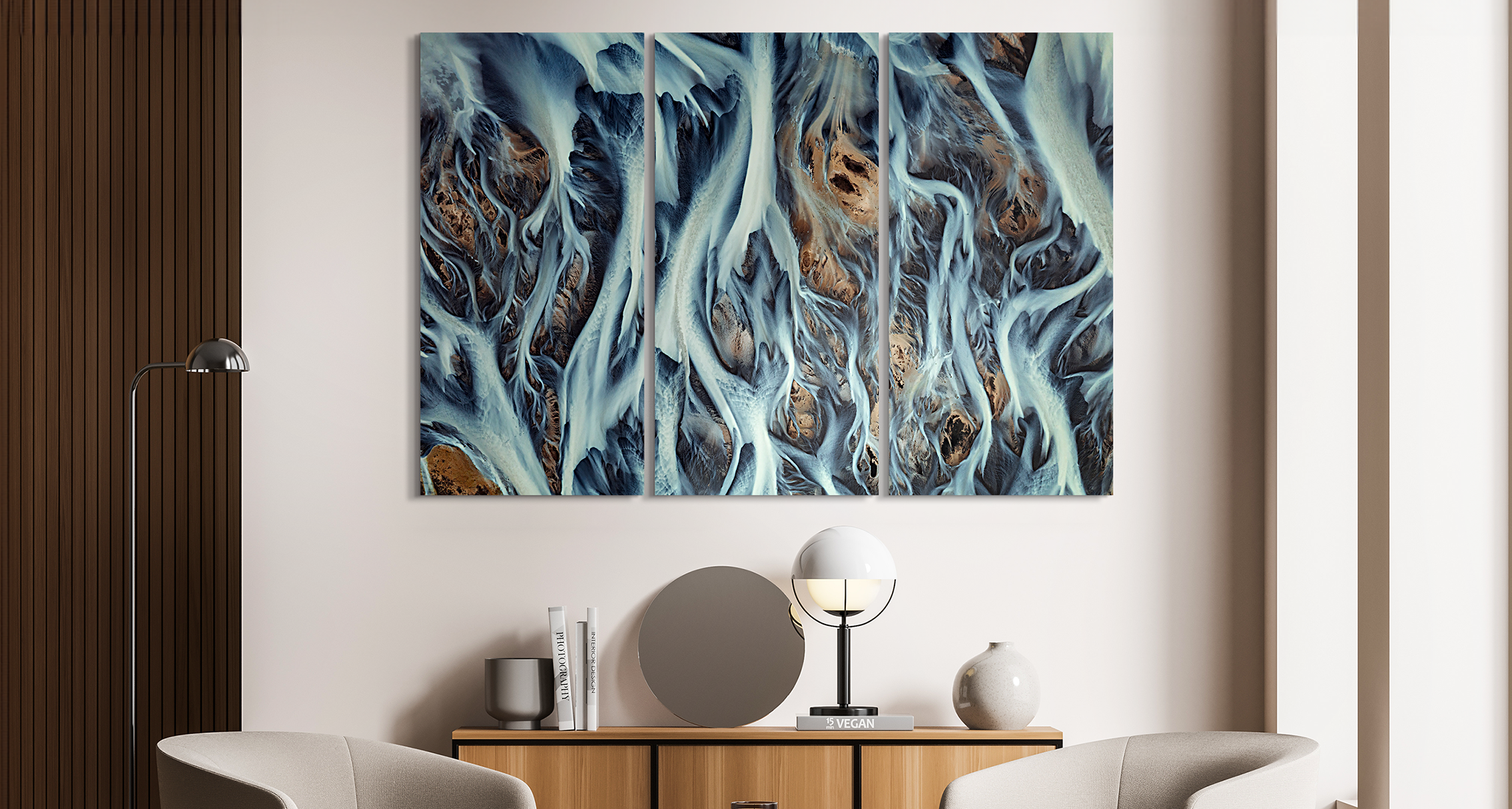 A big Photo Print under acrylic glass hanging on a wall in a living room and representing some blue and cold Iceland landscape from above.