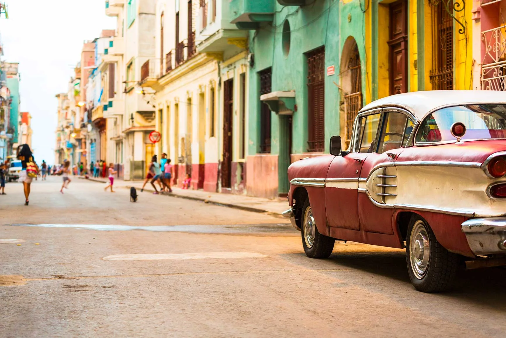Strada nei Caraibi con case colorate e un'auto americana classica degli anni '50. Strada nei Caraibi con case colorate e un'auto americana classica degli anni '50.