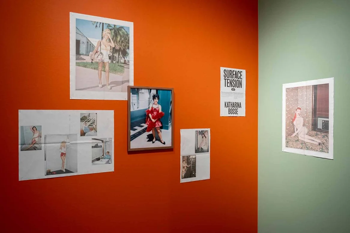 Photo Exhbition 40 Years Laif Fotogalerie mit arrangierten Fotografien an orange- und mintgrünen Wänden, zeigt die Ausstellung "Surface Tension" von Katharina Busse