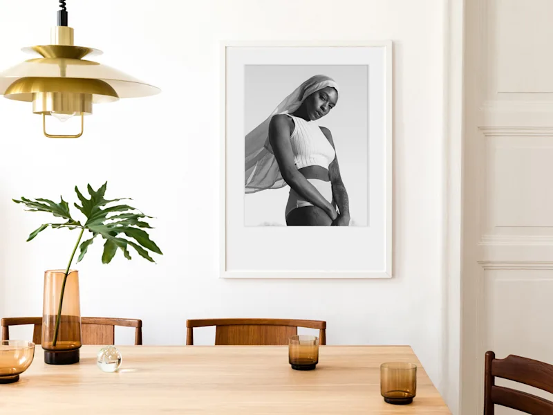 Photo Print On Ilford B/W Paper The black-and-white photo print from Ilford shows a woman in a white, sleeveless top in a frame hanging on a wall.
