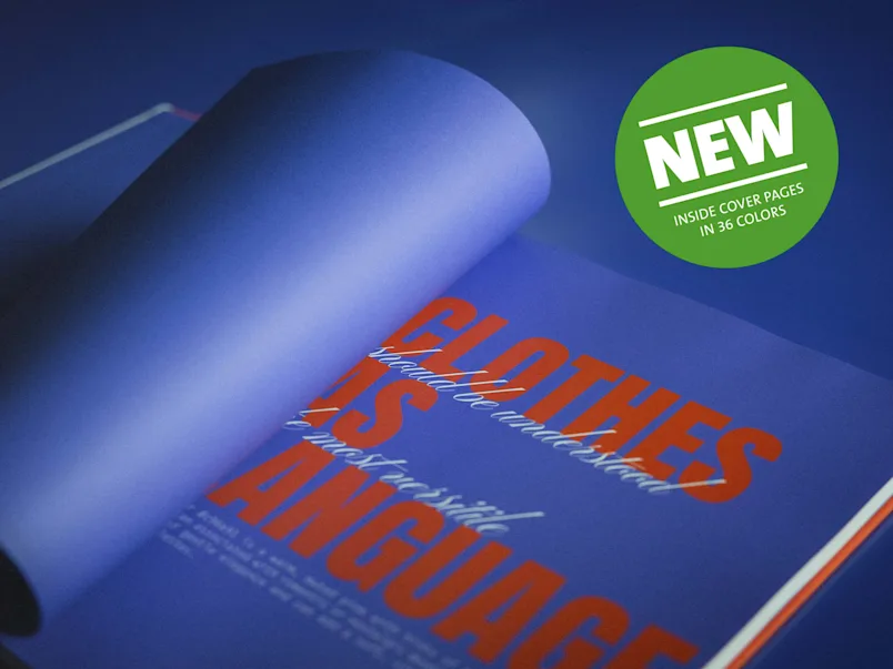 Coffee Table Book with colored endpapers Open Coffee Table Book page with purple background and large orange text 'CLOTHES IS LANGUAGE' and green sticker with white text 'NEW INSIDE COVER PAGES IN 36 COLORS'
