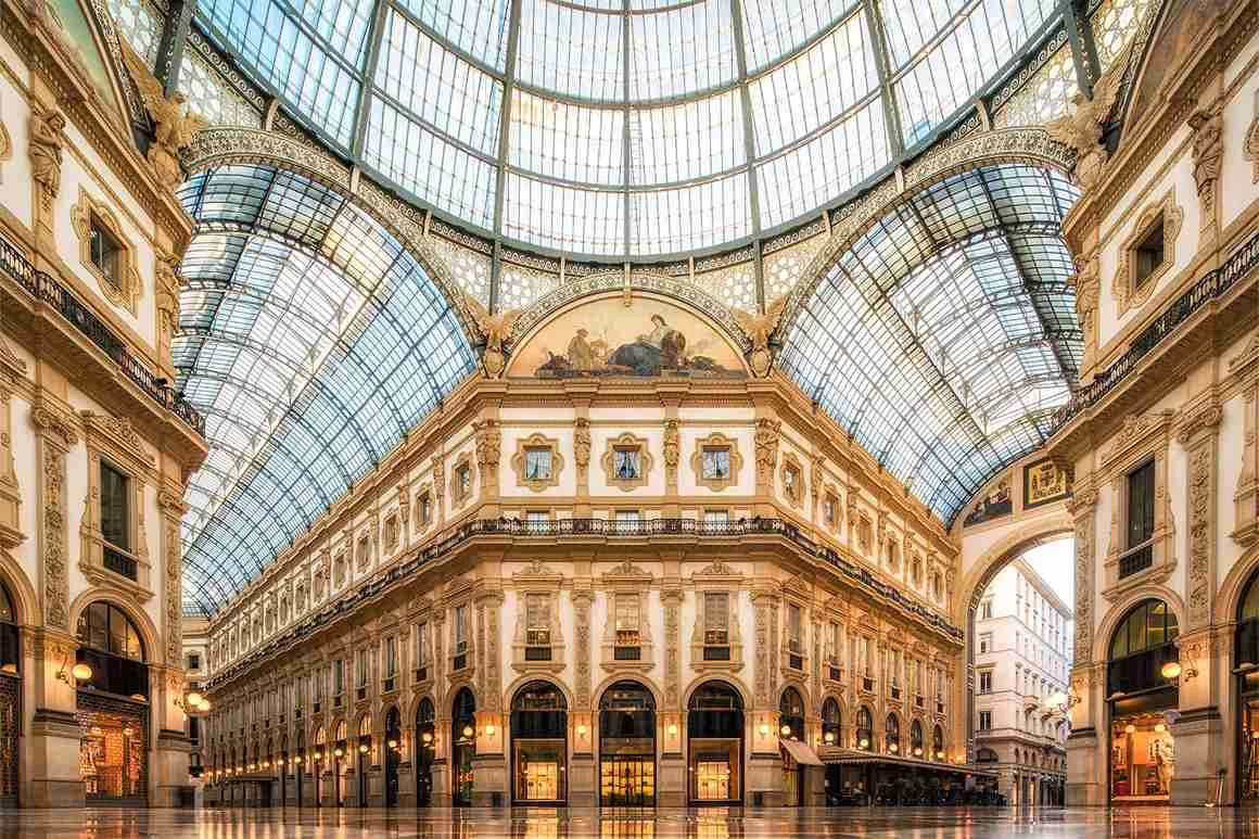 Shopping arcade with ornate facades A large shopping arcade with ornate facades and a vaulted glass roof.